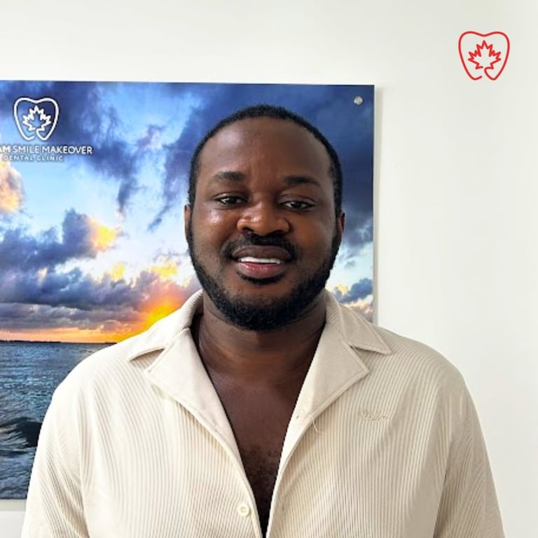 Man in cream button-up shirt smiling at camera with ocean sunset poster in background