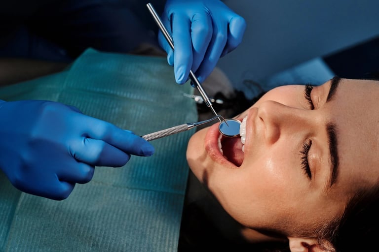 Dentist in blue gloves performing oral surgery or tooth extraction on a patient with mouth open