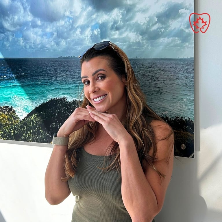 Woman smiling with hands near face in front of coastal ocean artwork with tropical beach scenery